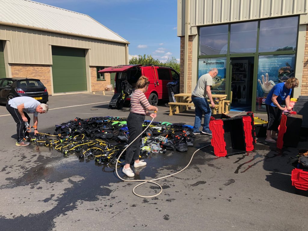 The stellar divers team rinsing dive kit after a pool session